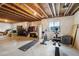 Unfinished basement area featuring workout equipment and exposed beams, ideal for customization and fitness at 2042 Shadow Creek Dr, Castle Rock, CO 80104