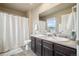 Neutral bathroom featuring double sinks, a large mirror, and a shower with a white curtain at 2042 Shadow Creek Dr, Castle Rock, CO 80104