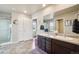 Bright primary bathroom with double sinks, vanity, and separate toilet room at 2042 Shadow Creek Dr, Castle Rock, CO 80104
