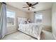 Comfortable bedroom with a ceiling fan, white comforter, and natural light at 2042 Shadow Creek Dr, Castle Rock, CO 80104