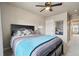 Comfortable bedroom features a large bed, ceiling fan, and a view into the hallway at 2042 Shadow Creek Dr, Castle Rock, CO 80104