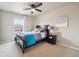 Cozy bedroom with a ceiling fan, a comfortable bed with blue blanket, and a decorative painting at 2042 Shadow Creek Dr, Castle Rock, CO 80104