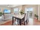 Open dining area with a marble-top table, views to the living room and access to the deck at 2042 Shadow Creek Dr, Castle Rock, CO 80104