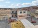 Charming two-story home with a well-manicured front yard and a blend of stone and siding accents at 2042 Shadow Creek Dr, Castle Rock, CO 80104