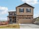 Inviting two-story home with stone accents, blue shutters and a two car garage at 2042 Shadow Creek Dr, Castle Rock, CO 80104