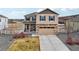 Inviting two-story home with stone accents, a well-maintained lawn and a two car garage at 2042 Shadow Creek Dr, Castle Rock, CO 80104