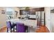 Kitchen island with granite countertops, a stainless steel fridge, and a gas range at 2042 Shadow Creek Dr, Castle Rock, CO 80104