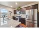 Modern kitchen features stainless steel appliances, granite countertops, and dark wood cabinets at 2042 Shadow Creek Dr, Castle Rock, CO 80104