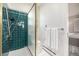 Bathroom featuring a green tiled shower and neutral walls at 3756 S Forest Way, Denver, CO 80237