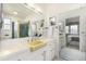 Bathroom featuring a yellow counter, ample mirror space, and access to the bedroom at 3756 S Forest Way, Denver, CO 80237