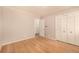 Bedroom featuring hardwood floors, neutral walls, and closet with white louvered doors at 3756 S Forest Way, Denver, CO 80237