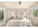 Bright bedroom showcasing a large bed, natural light, and contemporary artwork at 3756 S Forest Way, Denver, CO 80237