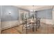 Charming dining room with a light fixture, a large area rug and sliding glass doors to the outdoors at 3756 S Forest Way, Denver, CO 80237