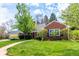 Lovely brick home with lush green lawn, mature trees, and a paved walkway leading to the entrance at 3756 S Forest Way, Denver, CO 80237