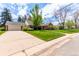 Well-maintained property with a brick home, an attached garage, a driveway, and a green front lawn at 3756 S Forest Way, Denver, CO 80237