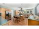 Bright, eat-in kitchen has an island with seating, stainless appliances and ample counter space at 3756 S Forest Way, Denver, CO 80237