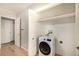 Laundry room featuring a modern washing machine and storage at 3756 S Forest Way, Denver, CO 80237