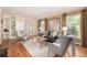 Sun-filled living room boasts hardwood floors, custom built-ins, and large picture windows at 3756 S Forest Way, Denver, CO 80237