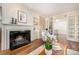 Cozy living room has a fireplace, custom built-ins, hardwood floors and lots of natural light at 3756 S Forest Way, Denver, CO 80237