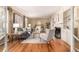 Bright living room features hardwood floors, neutral walls, fireplace, and large picture window at 3756 S Forest Way, Denver, CO 80237