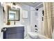 Updated bathroom featuring a vanity with modern sink, toilet, tub with white subway tile and decor at 43 S Logan St, Denver, CO 80209