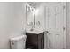 Updated bathroom with dark vanity and white toilet at 15934 E Columbia Pl, Aurora, CO 80013