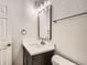 Modern bathroom with dark vanity, white countertop and fixtures at 15934 E Columbia Pl, Aurora, CO 80013