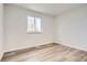 Bright bedroom with wood-look floors and large window at 15934 E Columbia Pl, Aurora, CO 80013