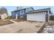 Ranch style home with blue siding, brick accents, and a two-car garage at 15934 E Columbia Pl, Aurora, CO 80013