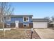 Newly remodeled home featuring blue siding and a two-car garage at 15934 E Columbia Pl, Aurora, CO 80013