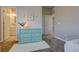 Stylish bedroom with a light-blue dresser, a decorative picture and bathroom access at 14445 Hop Clover Trl, Parker, CO 80134