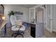 Comfortable home office featuring a modern desk, a plush chair, and a view to the hallway at 14445 Hop Clover Trl, Parker, CO 80134