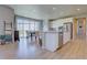 Modern kitchen open to dining area, featuring white cabinets, stainless steel appliances, and island seating at 14445 Hop Clover Trl, Parker, CO 80134