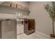 Organized laundry room featuring new washer and dryer units, and storage shelving with baskets at 14445 Hop Clover Trl, Parker, CO 80134