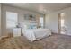 Well-lit main bedroom showcases a comfortable bed, side tables, and calming neutral tones at 14445 Hop Clover Trl, Parker, CO 80134