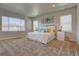 Spacious main bedroom featuring neutral decor, plush carpet, and bright natural light from large windows at 14445 Hop Clover Trl, Parker, CO 80134