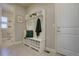 Mud room with a tiled floor, white hall tree, and access to a half-bath at 14445 Hop Clover Trl, Parker, CO 80134