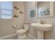 Stylish half-bath with pedestal sink, and decorative wall art at 14445 Hop Clover Trl, Parker, CO 80134