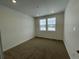 Well-lit bedroom with neutral carpeting and dual windows at 16602 E 109Th Ave, Commerce City, CO 80022