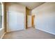 Well-lit bedroom with double sliding doors and carpet flooring at 841 W 128Th Pl, Westminster, CO 80234