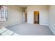 Bright bedroom with large window, carpet flooring, and access to bathroom at 841 W 128Th Pl, Westminster, CO 80234