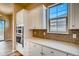 Built-in oven and white cabinets are featured in this kitchen at 841 W 128Th Pl, Westminster, CO 80234