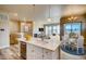 Modern kitchen with island, white cabinets, and stainless steel appliances at 841 W 128Th Pl, Westminster, CO 80234