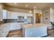 Modern kitchen with white cabinets and an island at 841 W 128Th Pl, Westminster, CO 80234