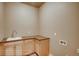 Laundry room with corner sink and wooden cabinets at 841 W 128Th Pl, Westminster, CO 80234