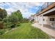 Landscaped backyard with a concrete patio and lush green lawn at 21062 Hawthorne Ln, Parker, CO 80138