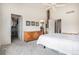 Comfortable bedroom featuring an ensuite bath, walk-in closet and white walls at 21062 Hawthorne Ln, Parker, CO 80138