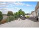 Wide shot of an outdoor deck with wicker furniture and a view of greenery at 21062 Hawthorne Ln, Parker, CO 80138
