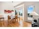 Bright dining room with hardwood floors, white walls, and lots of natural light through large windows and a glass door at 21062 Hawthorne Ln, Parker, CO 80138