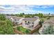 Stunning rear exterior view featuring a spacious backyard with a well-manicured lawn, mature trees, and a private deck at 21062 Hawthorne Ln, Parker, CO 80138